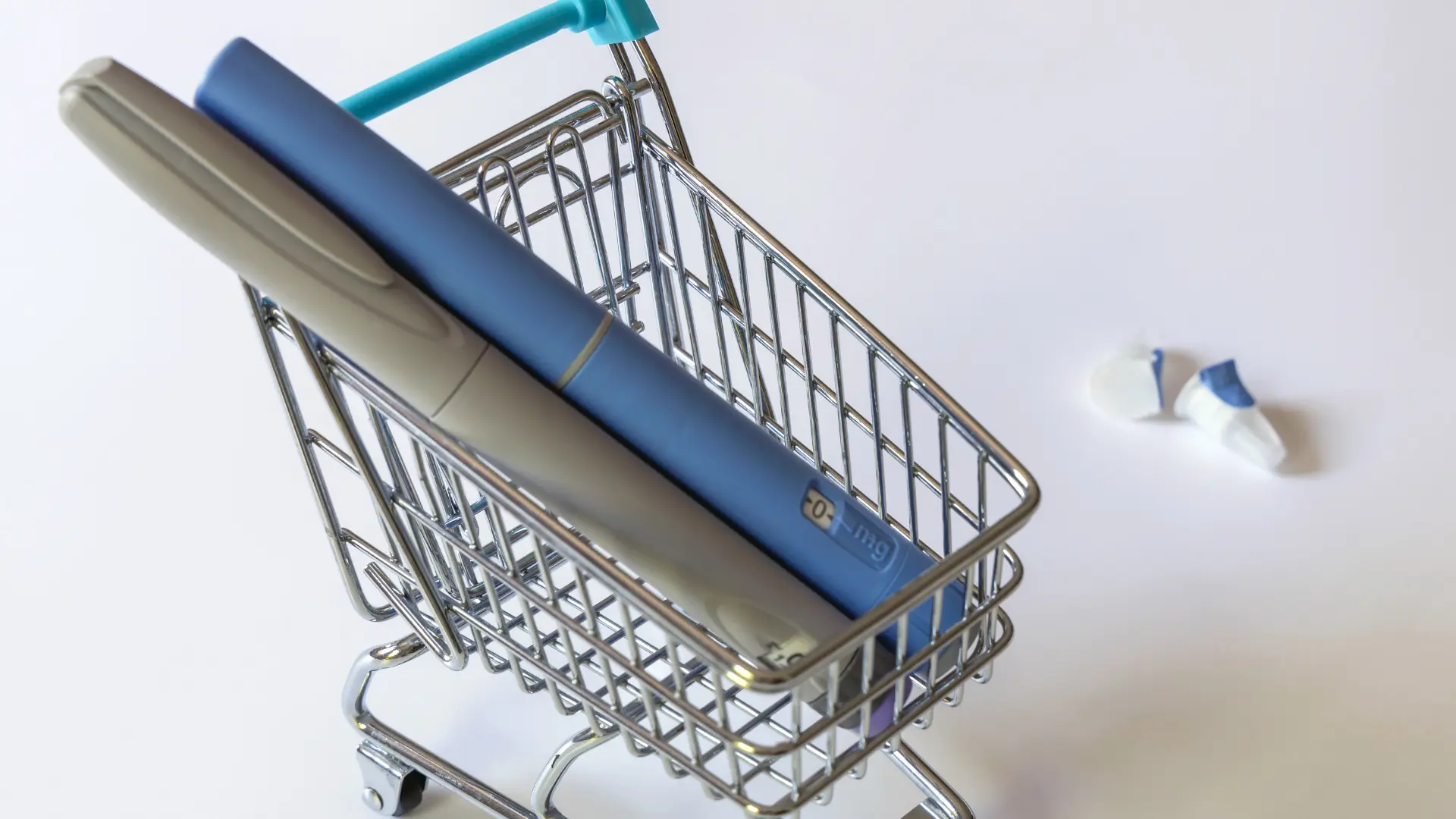 Two injectable pens in a small shopping cart.