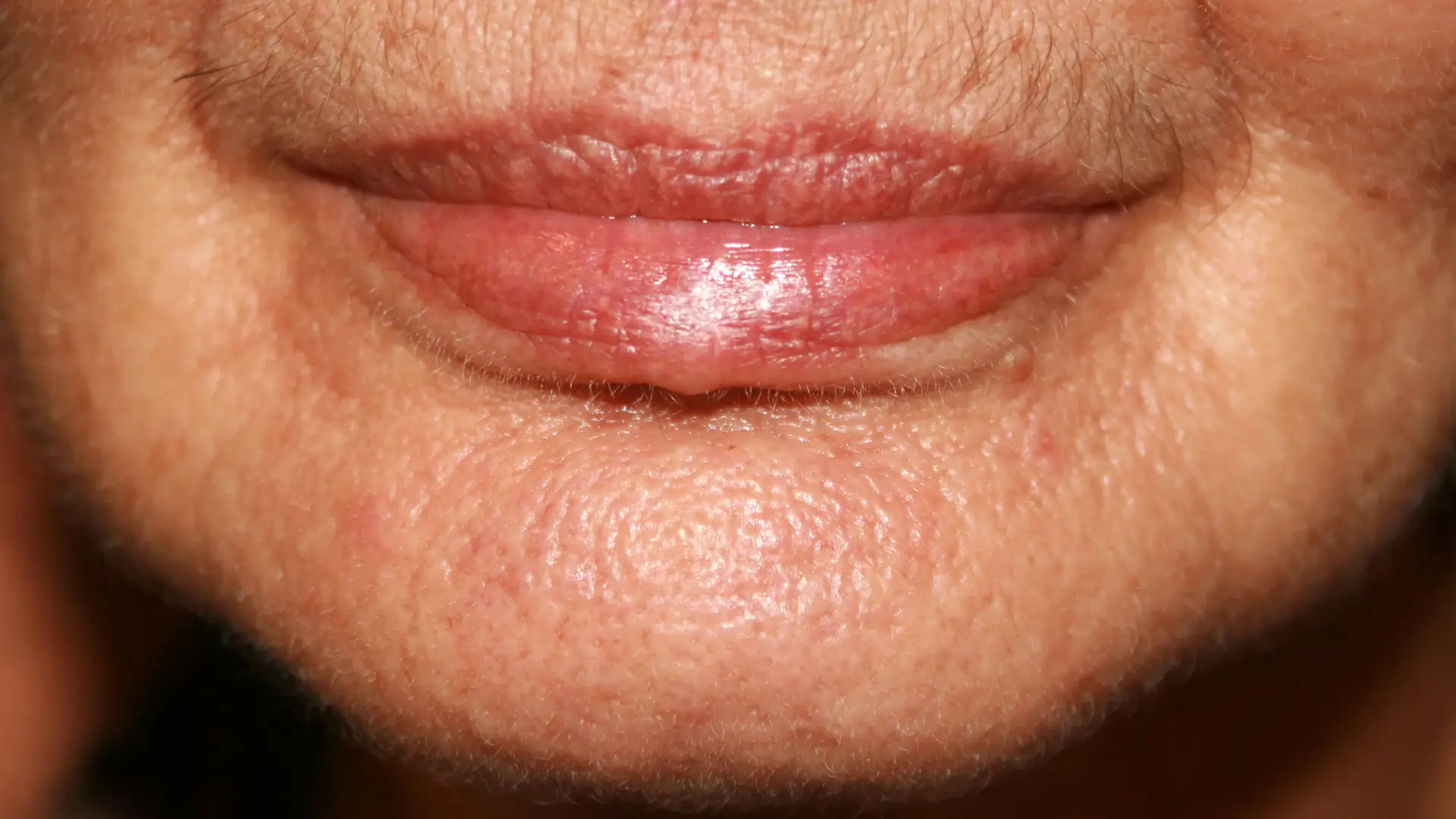 A close-up shot of an older individual's lower facial region.