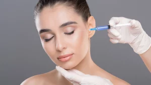 An aesthetic provider administering a facial injection into a patient.